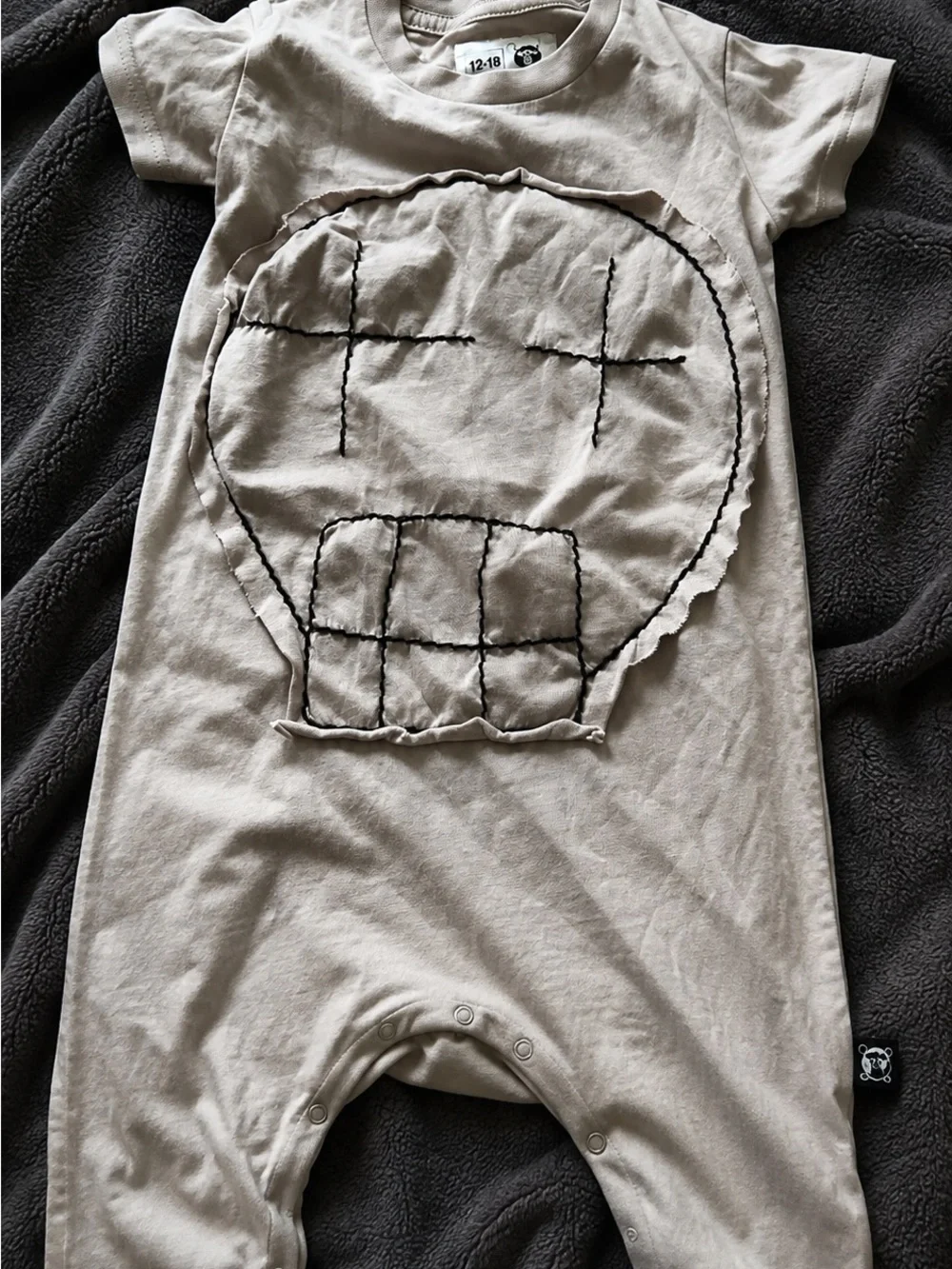 Nununu Beige Baby One-Piece with Skull Patch